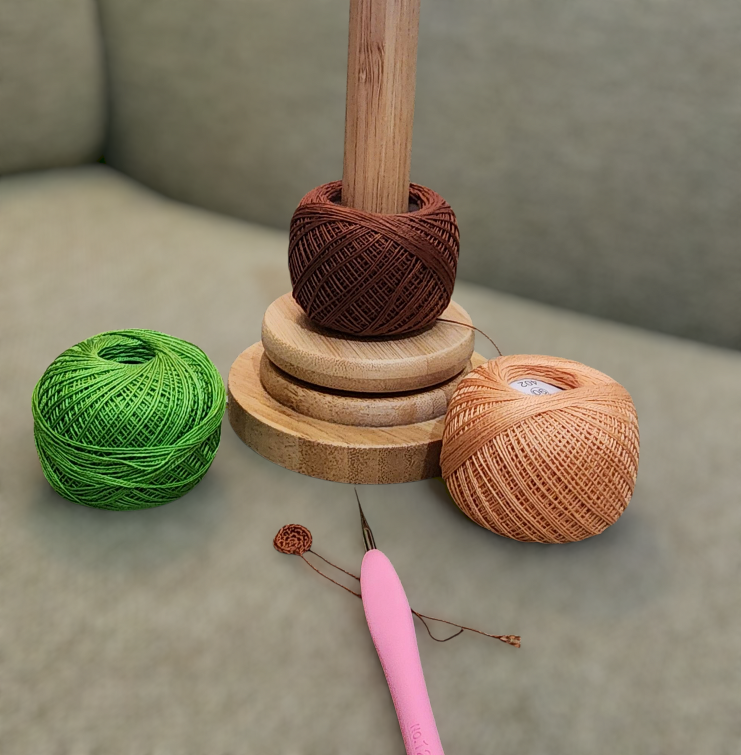A trio of crochet yarn and hook representing the art of crocheting