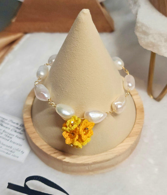 10-12mm natural baroque pearls bracelet with a vibrant handcrafted yellow micro-crochet star flower cluster. 18K gold-plated bracelet.