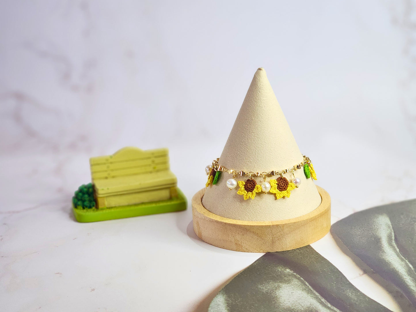 Handcrafted micro-crochet sunflowers & pearls bracelet. 6-7mm oval freshwater pearls set on 14K gold-plated adjustable chain.