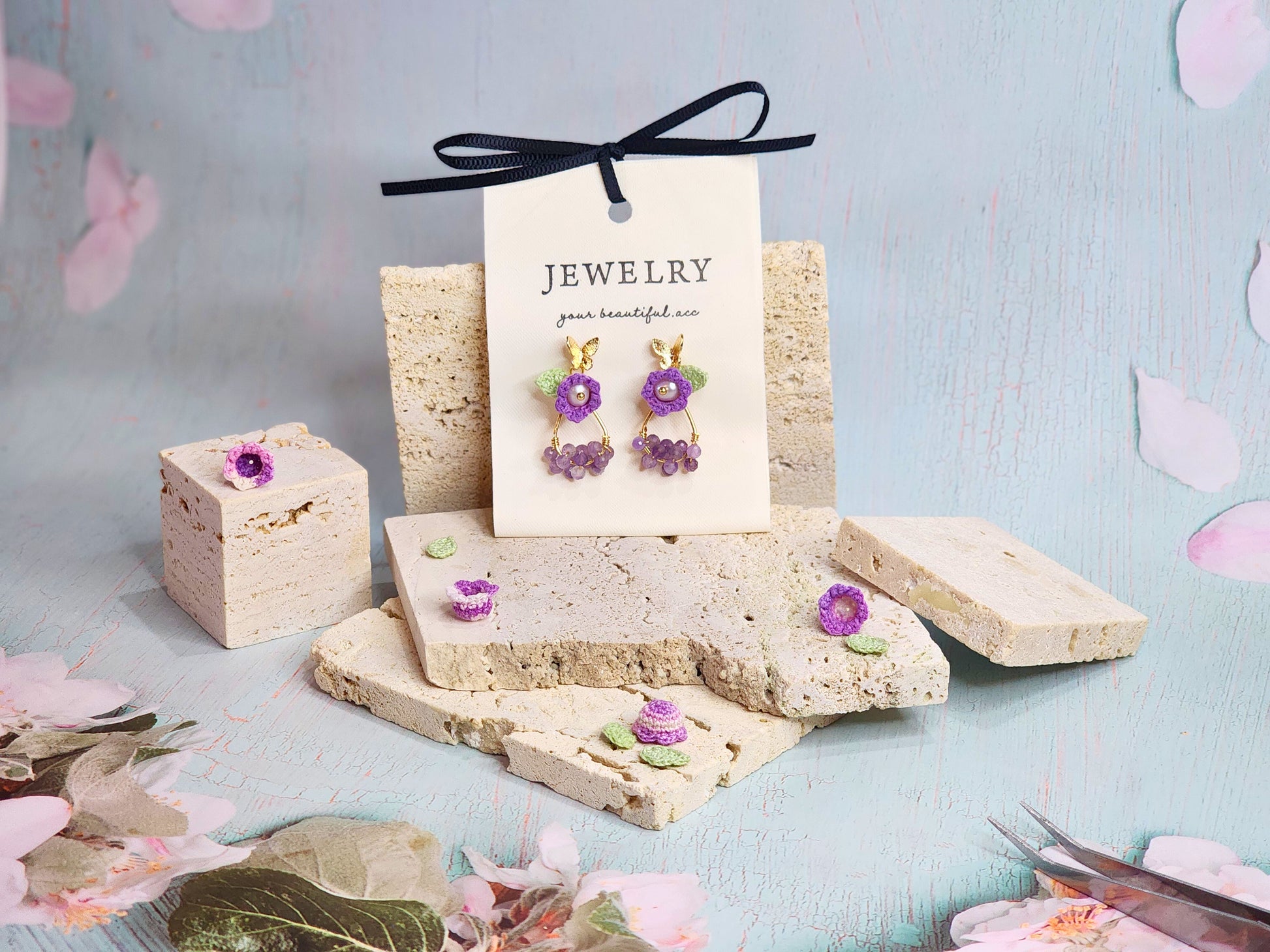 Natural Amethyst earrings with handcrafted micro‑crochet Lily of the Valley adorned with natural 4.5-5mm smoke grey freshwater pearls.