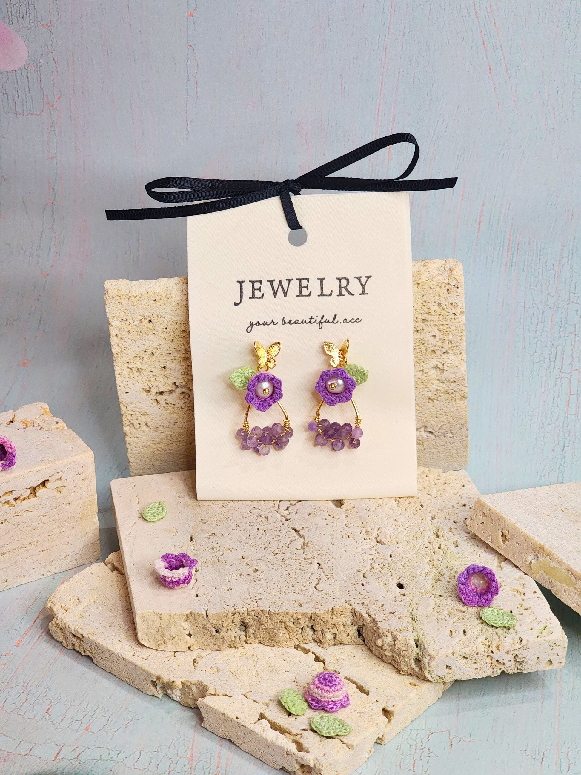 Natural Amethyst earrings with handcrafted micro‑crochet Lily of the Valley adorned with natural 4.5-5mm smoke grey freshwater pearls.