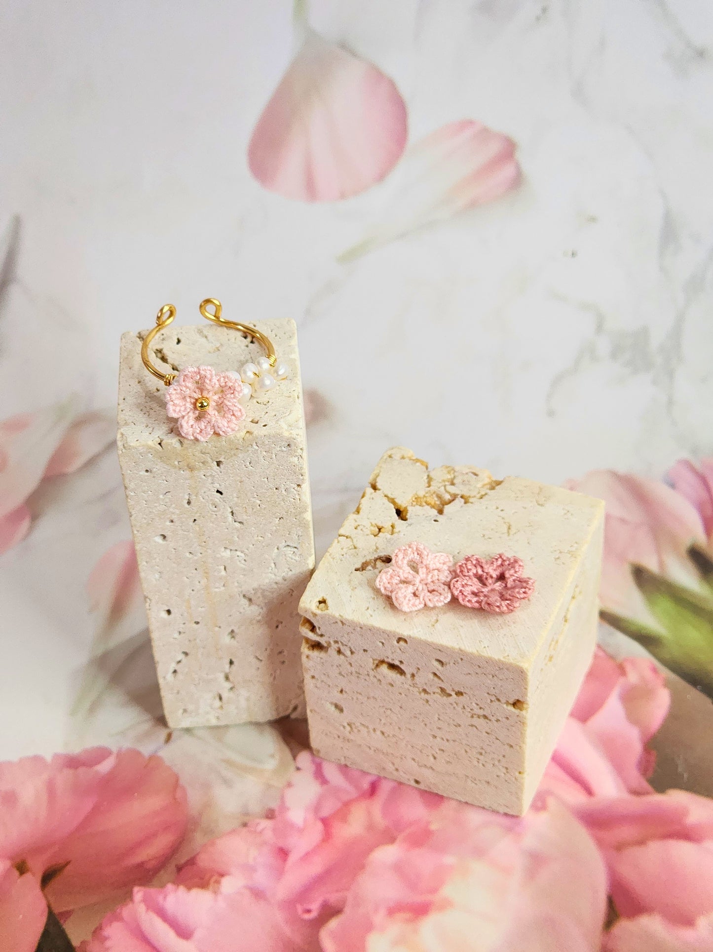 Band of natural freshwater pearls ring adorned with a delicately handcrafted micro‑crochet Sakura. 18K gold-plated adjustable ring.