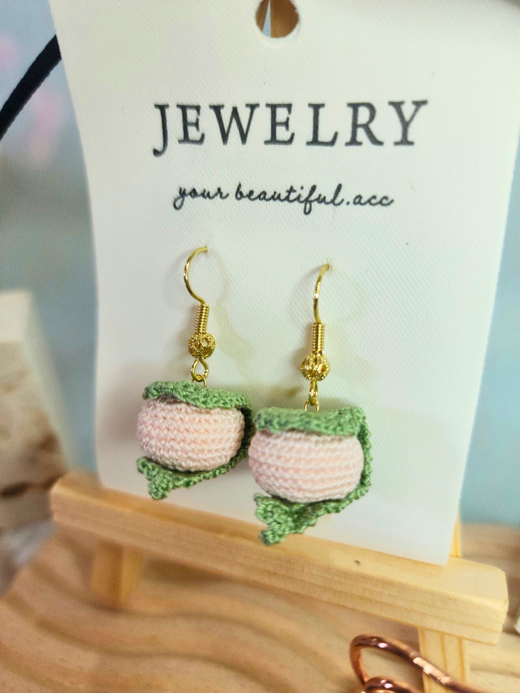 A pair of sweet Sakura mochi micro-crochet earrings handcrafted with ultra-fine lace yarn and 18K gold-plated hooks