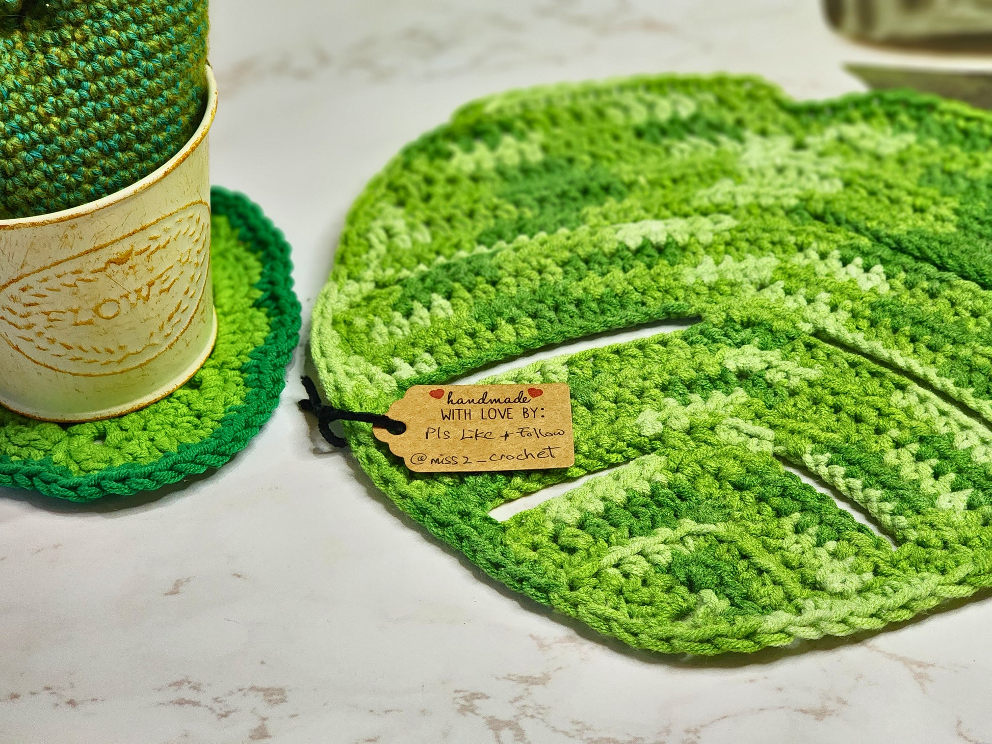 Large Monstera crocheted table centerpiece in varying shades of green