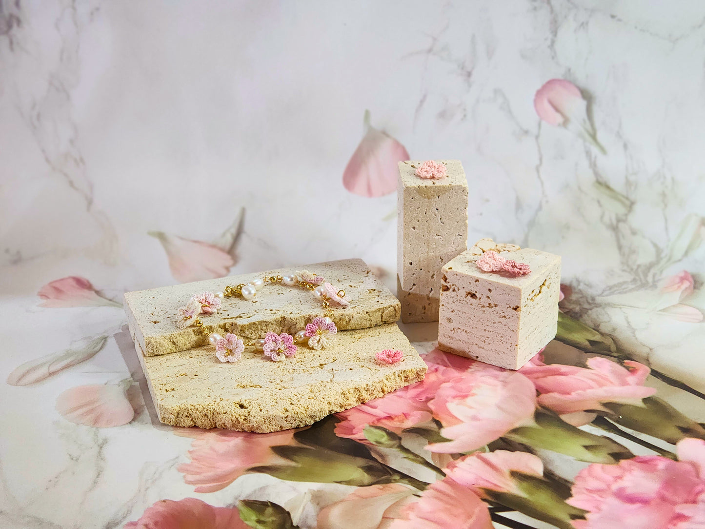 Handcrafted pink-white micro‑crochet Sakura blossoms, flanked by 5-6mm natural Baroque pearls. 14K gold-plated bracelet.