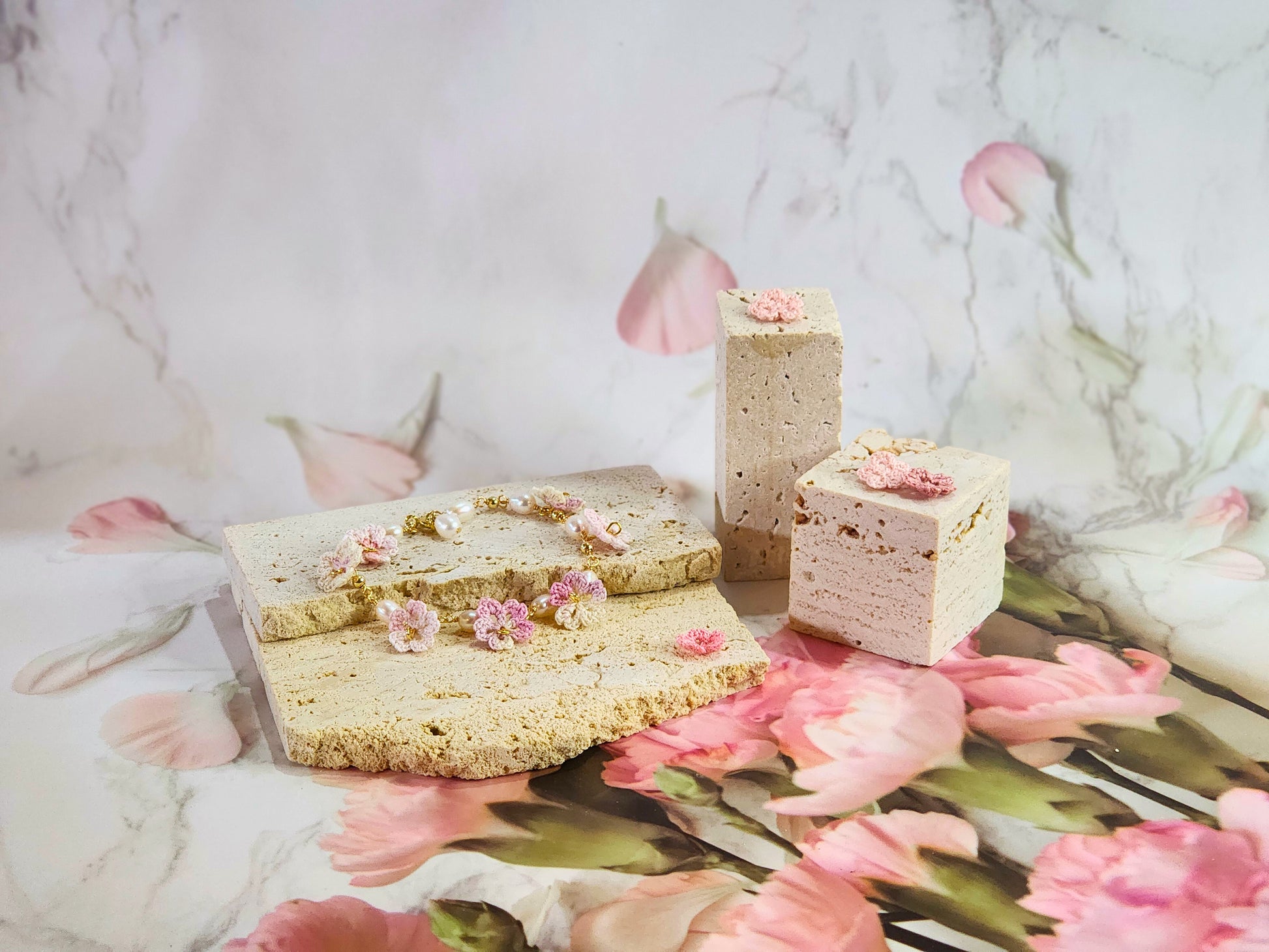 Handcrafted pink-white micro‑crochet Sakura blossoms, flanked by 5-6mm natural Baroque pearls. 14K gold-plated bracelet.