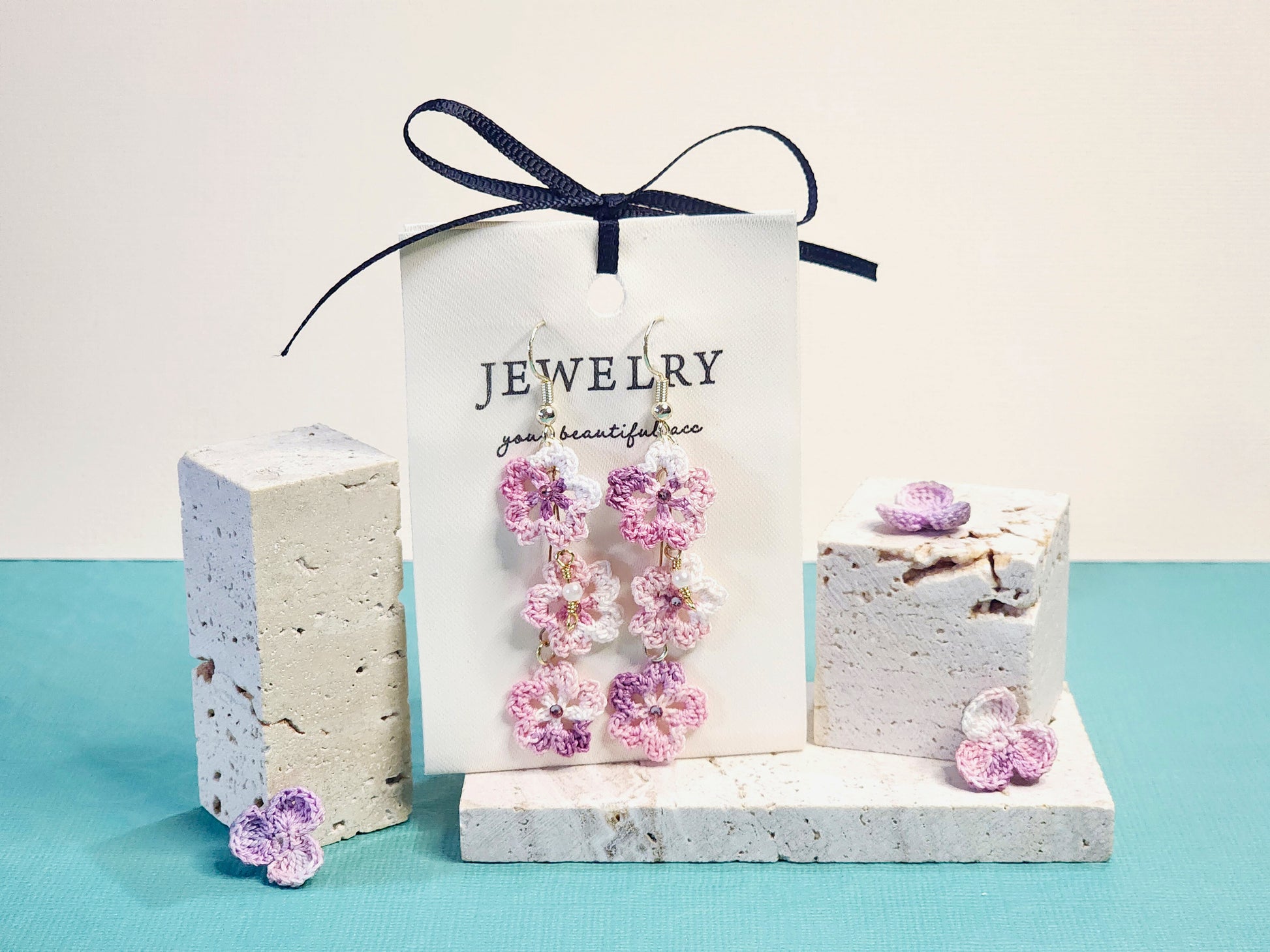 A pair of luxury micro-crochet Sakura Trio chandelier earrings