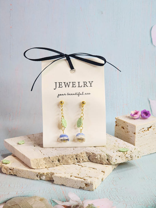 Collection of handcrafted White-blue micro-crochet Lily of the Valley dangle and chandelier earrings. 18K gold-plated studs and chains.