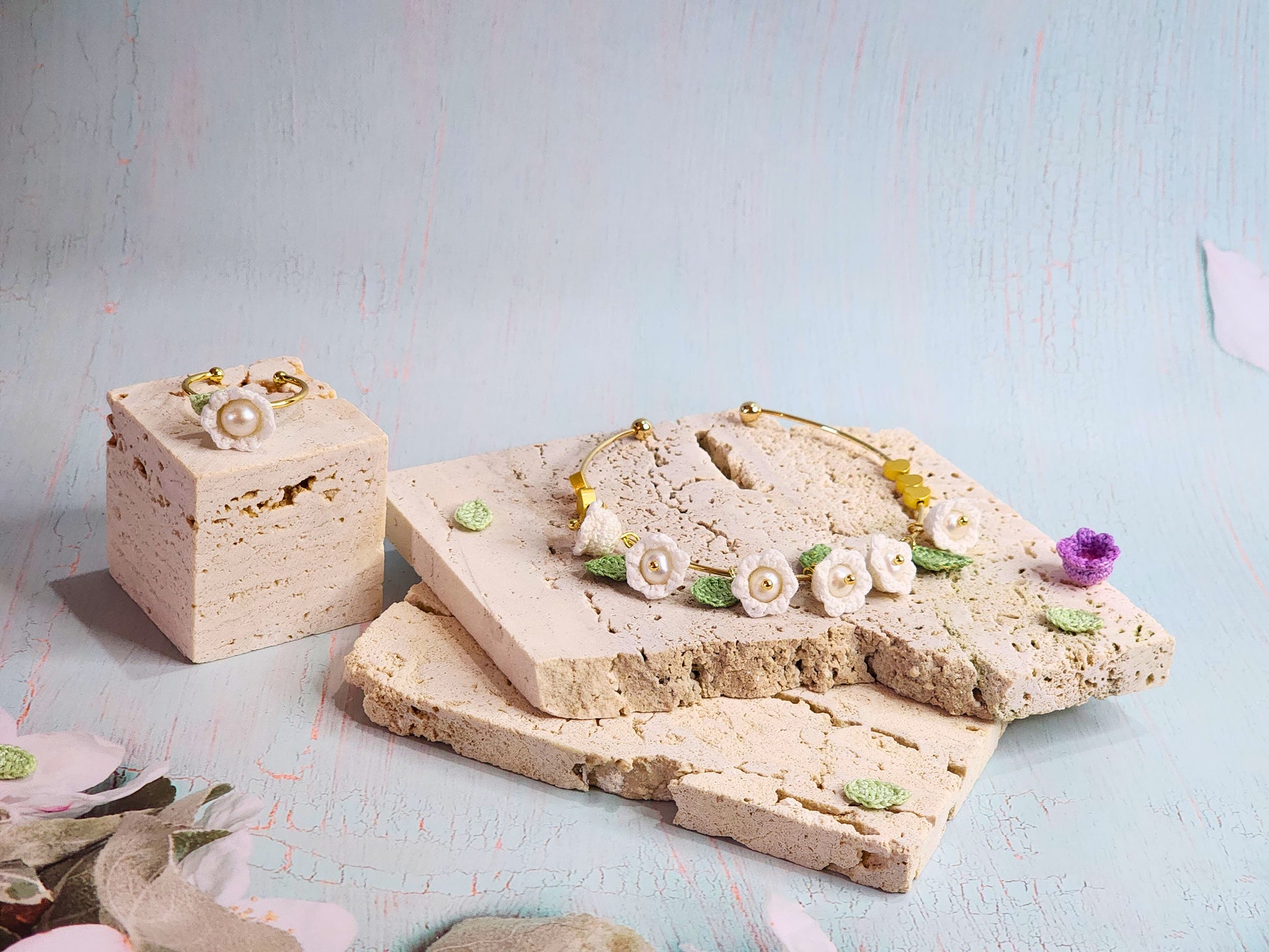 Handcrafted white micro-crochet Lily of the Valley with pearls collection, featuring ring, bracelet and earrings. 18K gold-plated.