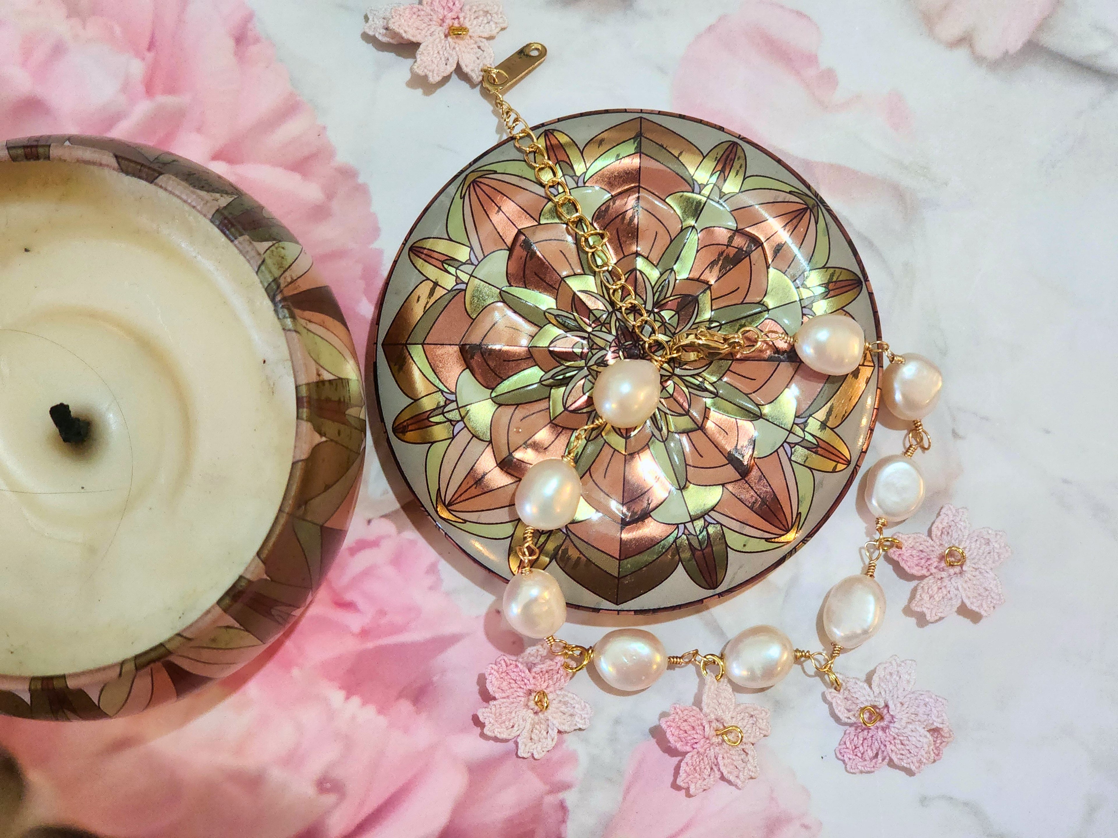 Natural 8-9mm Baroque Pearls bracelet with handcrafted micro-crochet Sakura blossoms. 18K gold-plated adjustable bracelet.