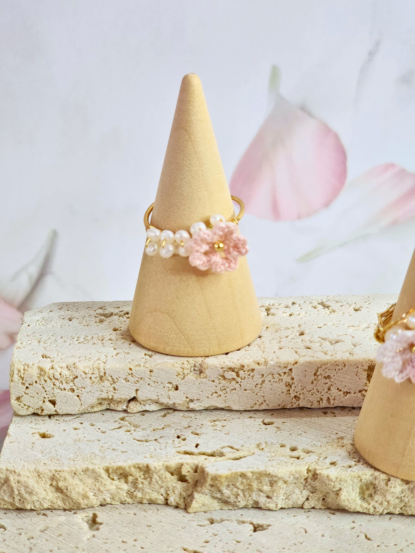 Band of natural freshwater pearls ring adorned with a delicately handcrafted micro‑crochet Sakura. 18K gold-plated adjustable ring.