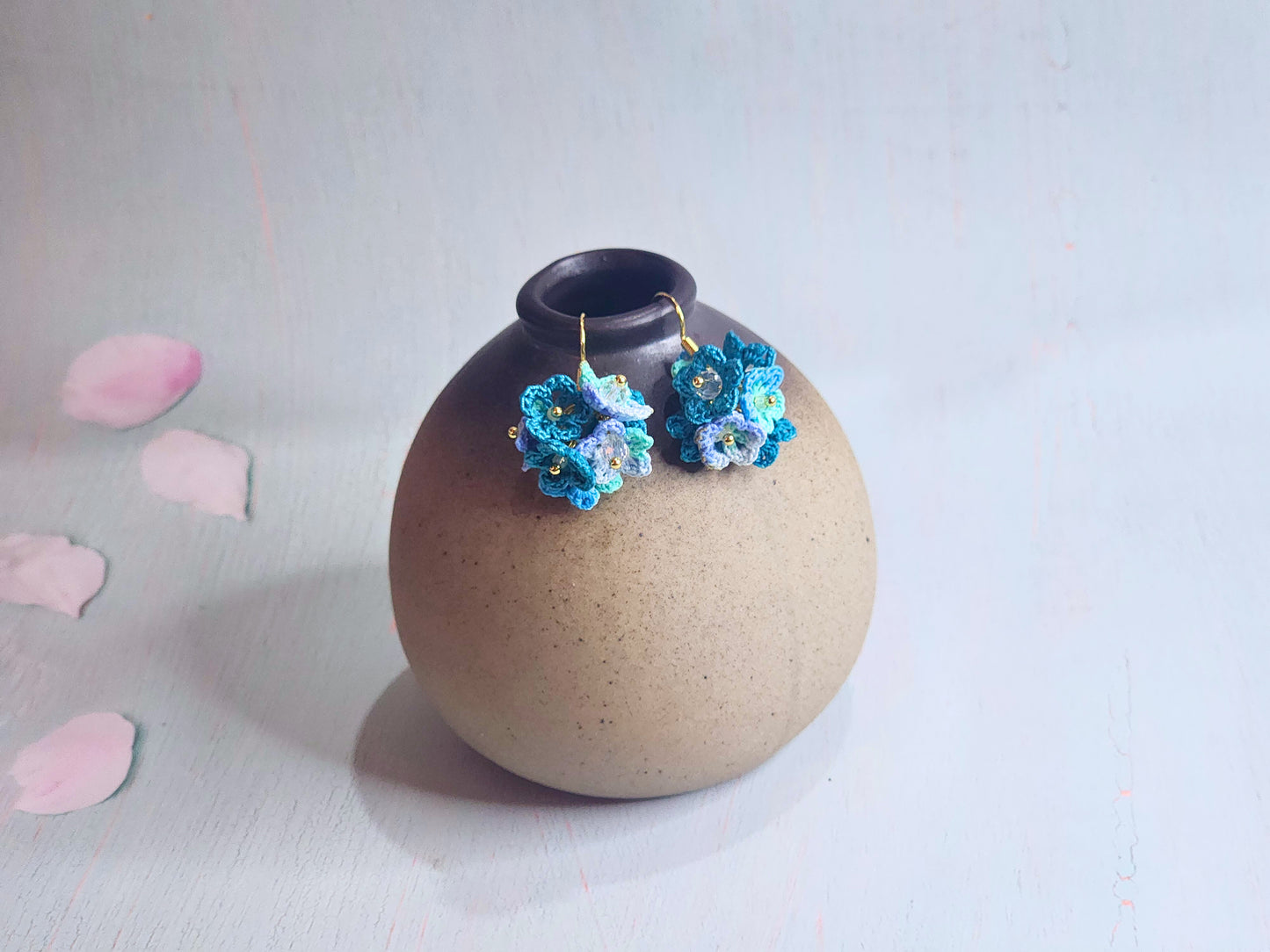 Handcrafted cluster of blue micro-crocheted star flower earrings in a lightweight and elegant design. Accented with Miyuki glass beads from Japan.