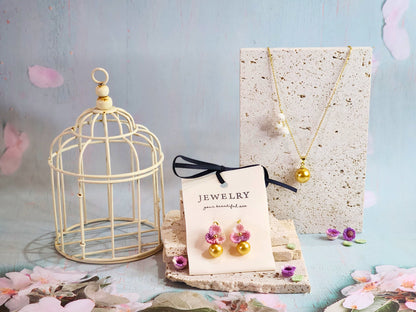 Collection of Dark gold South Sea pearl earrings and necklace with handcrafted micro‑crochet blossoms, on 18K gold-plated ear hooks and chain 