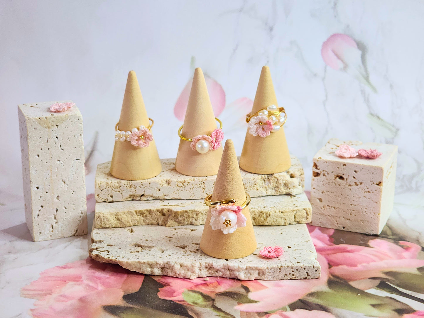 Collection of micro-crochet Sakura blossoms crowned with natural freshwater pearls on gold-plated adjustable rings