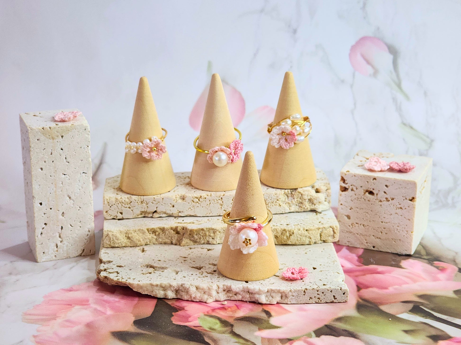 Collection of micro-crochet Sakura blossoms crowned with natural freshwater pearls on gold-plated adjustable rings