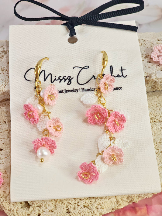 Handcrafted asymmetrical chandelier earrings featuring multiple tiers of micro-crochet Sakura and natural 4-5mm Baroque pearls