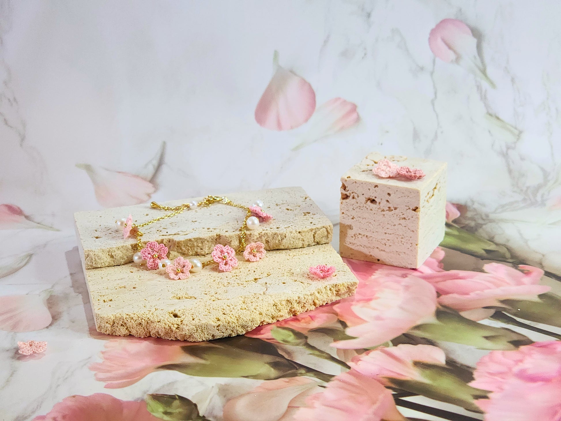 Handcrafted micro-crochet Sakura blossoms flanked by natural 5-6mm freshwater pearls on an 14K gold-plated bracelet. 