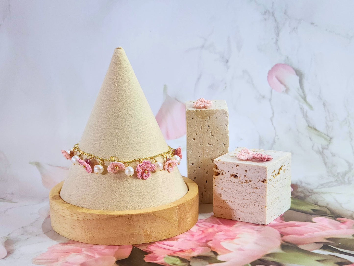 Handcrafted micro-crochet Sakura blossoms flanked by natural 5-6mm freshwater pearls on an 14K gold-plated bracelet. 