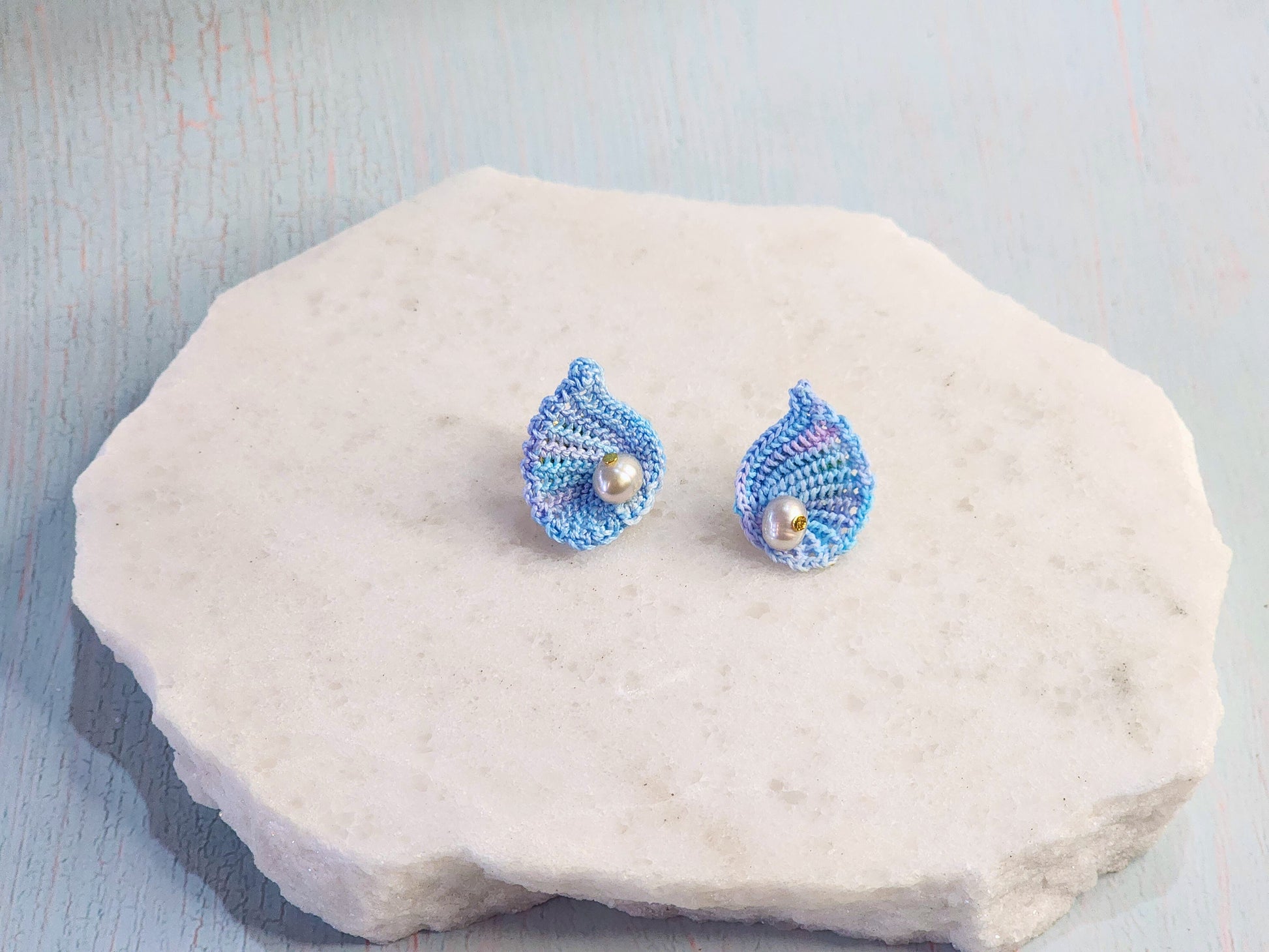 Handcrafted micro-crochet blue scallop earrings with 5-5.5mm natural smoke grey baroque pearls. 18K gold-plated ear studs. 