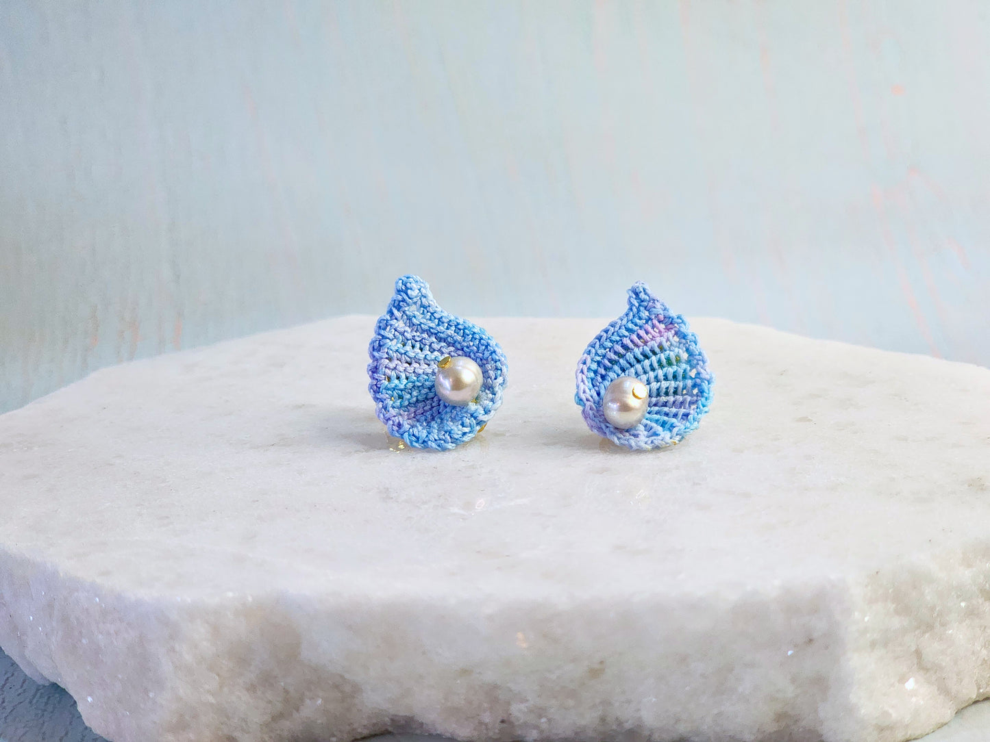Handcrafted micro-crochet blue scallop earrings with 5-5.5mm natural smoke grey baroque pearls. 18K gold-plated ear studs. 
